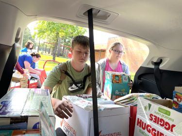 St. James Middle School students load boxes of baby supplies into an SUV. The school's Junior Beta Club donated the items to Tidelands Health Pediatrics.