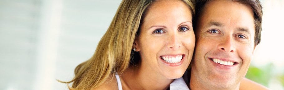 A young couple smiling.