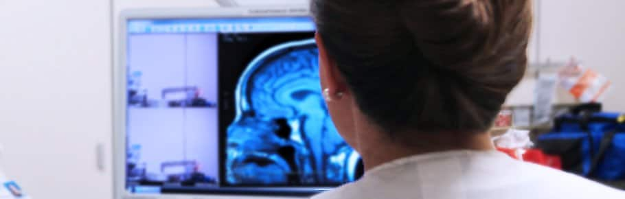 A stroke specialist reviews her monitor to check for signs of stroke in a patient.