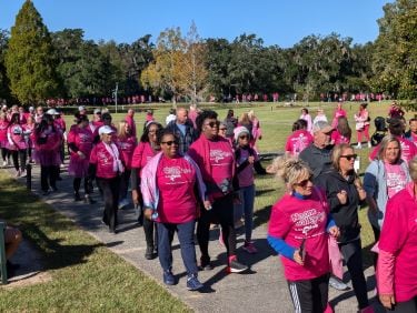 Walkers wearing pink fill the sidewalks at Brookgreen Gardens as they participate in the Tidelands Health In the Pink breast cancer awareness walk 2024.