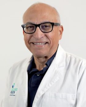 Dr. Raif Elsakr wearing his physician's white coat