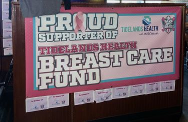 Banner hangs in Dagwood's restaurant saying it's a proud supporter of the Tidelands Health Breast Care Fund.